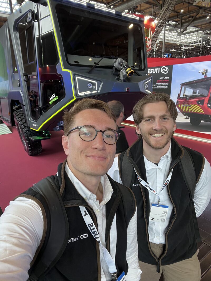 DealFlowAgent team Tom and Kaya at Interschutz 2026 in Hannover, beside an Iturri Tekla fire truck